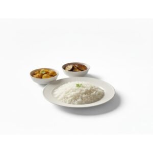 White steamed rice served on a plate with spicy cauliflower curry and fried eggplant sides on white background.