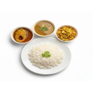 Plate of steamed rice served with fish curry, dal and cabbage fry on white background.